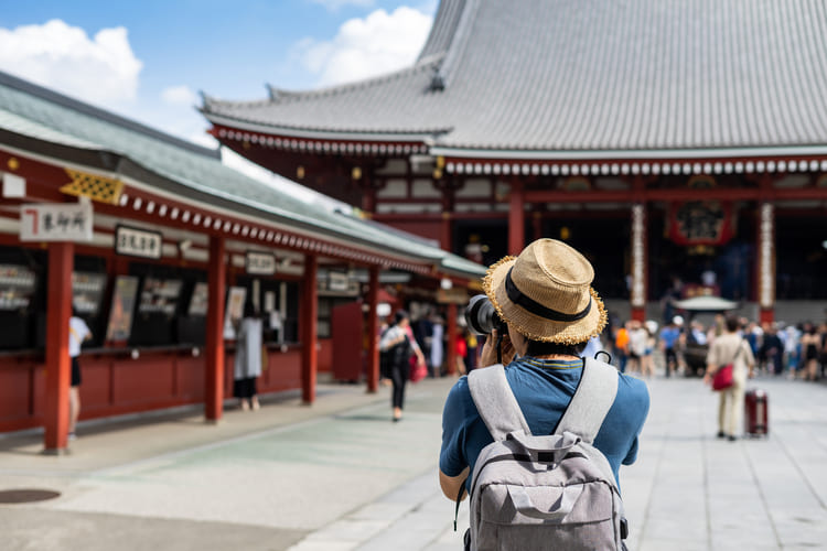 young traveler taking photo of sensoji temple